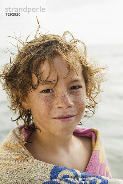 Spain  Portrait of boy at Atlantic Ocean  smiling