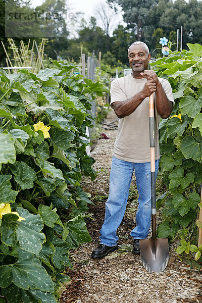 angelehnt Mann schwarz Schaufel Gemeinschaftsgarten