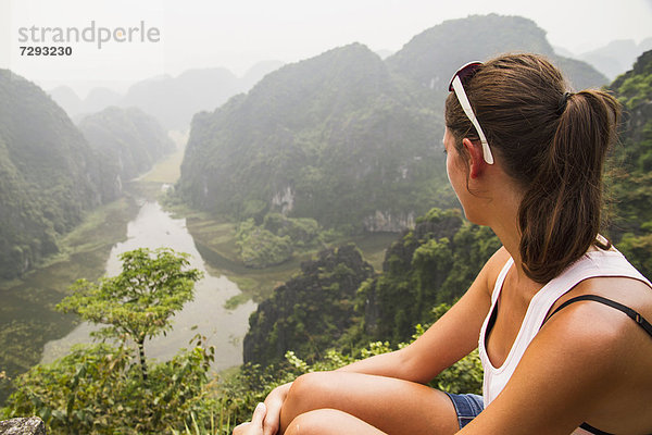 Vietnam  Ninh Binh  Young tourist looking down to Tom Coc valley