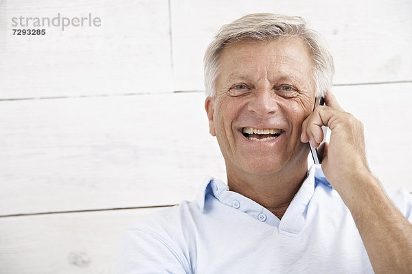 Spanien  Senior auf dem Handy  lächelnd  Portrait