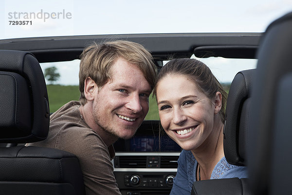 Germany  Bavaria  Couple in car  smiling