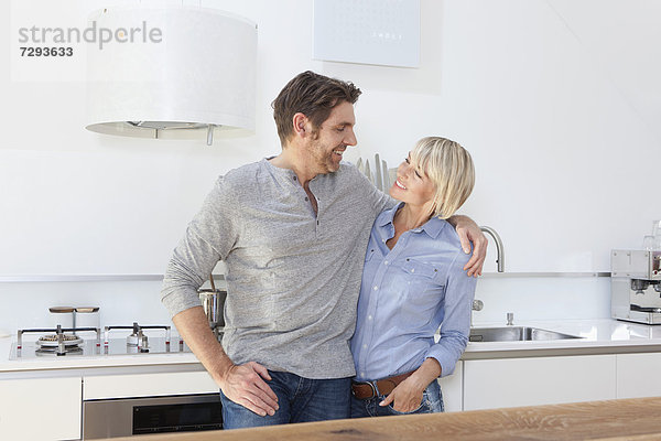 Germany  Bavaria  Munich  Mature couple in kitchen  smiling