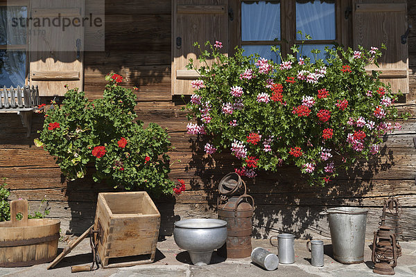 Germany  Bavaria  Geranium and househols articles on terrace of farmhouse