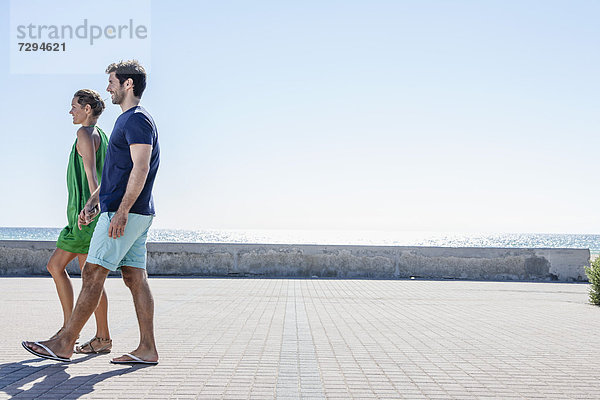 Spain  Mid adult couple walking on pavement