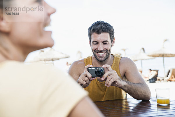 Spain  Mid adult man taking photograph of woman