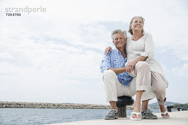 Spain  Senior couple at harbour  smiling