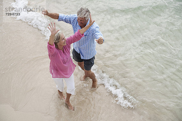 Spain  Seniors couple dancing on beach