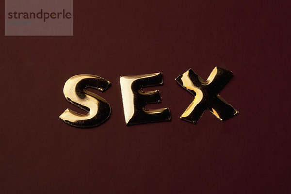 Das Wort'Sex' in goldenem Schriftzug