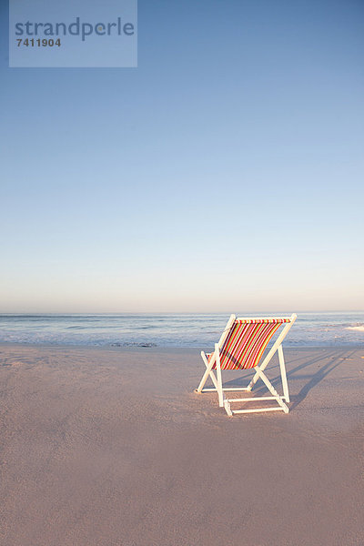 Liegestuhl am leeren Strand