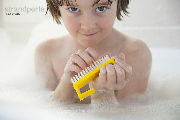 Mädchen schrubbt ihre Nägel in der Badewanne