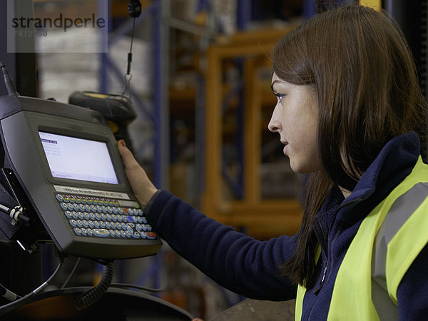 Arbeiter mit Gabelstapler im Lager