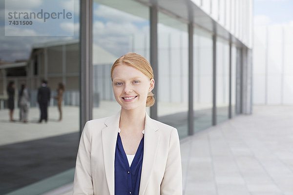 Porträt einer lächelnden Geschäftsfrau vor dem Gebäude