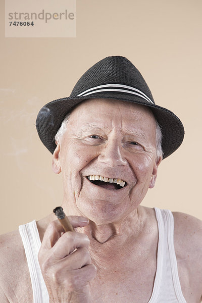 rauchen  rauchend  raucht  qualm  qualmend  qualmt  hoch  oben  nahe  Senior  Senioren  Portrait  Mann  lächeln  Hut  Zigarre  Kleidung