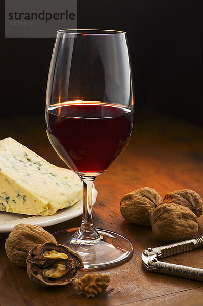 Still life with red wine  nuts and cheese