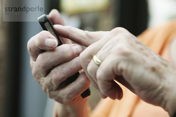 Seniorin mit Smartphone in der Hand