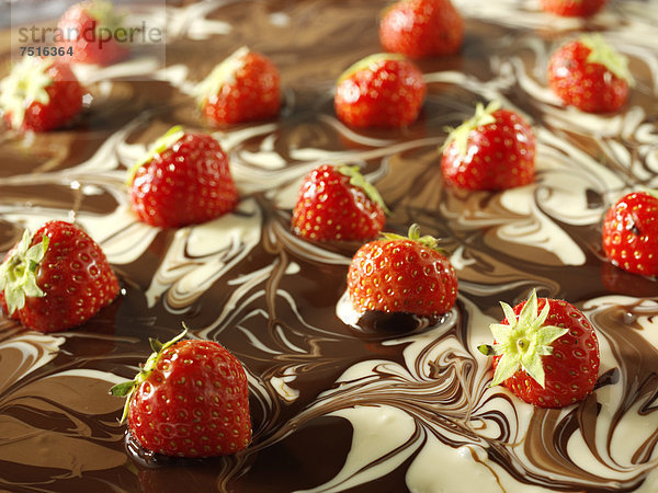 Muster aus weißer Schokolade und Milchschokolade mit Erdbeeren