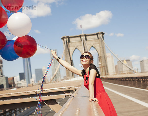 Frau mit Luftballons auf der Stadtbrücke