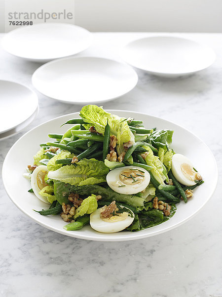 Teller mit grünen Bohnen und Walnuss-Salat