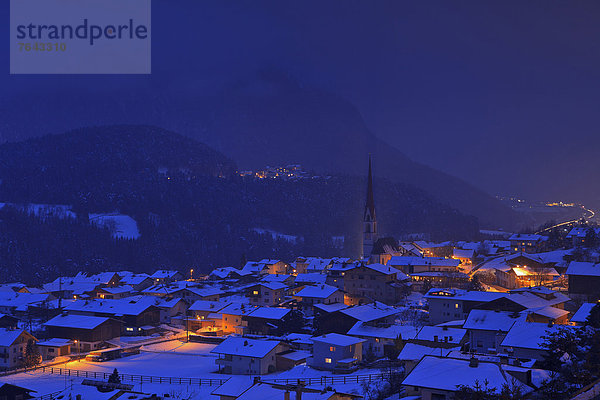 Europa Winter Urlaub Wolke Wohnhaus Reise Abend Nacht gelb Gebäude Wald Nebel Kirche Beleuchtung Licht Holz blau Österreich Imst Schnee Tirol