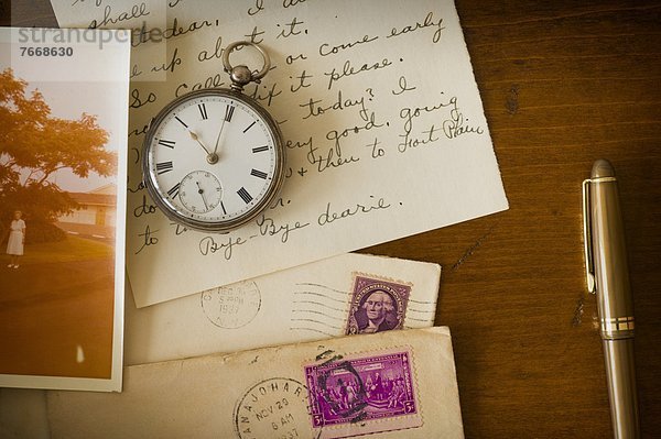 Still life with pocket watch  old letter and photograph