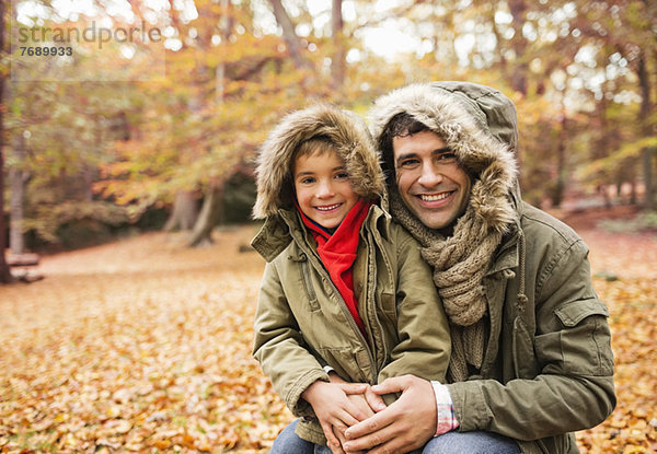 Vater und Sohn lächeln im Park