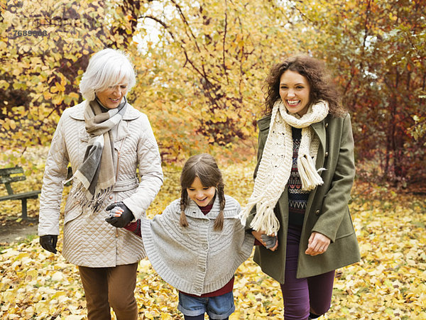 Drei Generationen von Frauen  die im Park spazieren gehen.