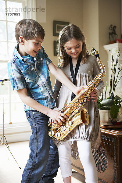 Kinder spielen mit Saxophon
