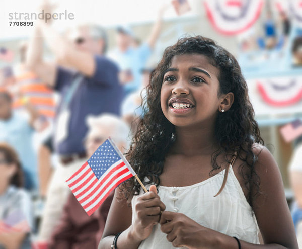 Mädchen mit amerikanischer Flagge  die ängstlich schaut