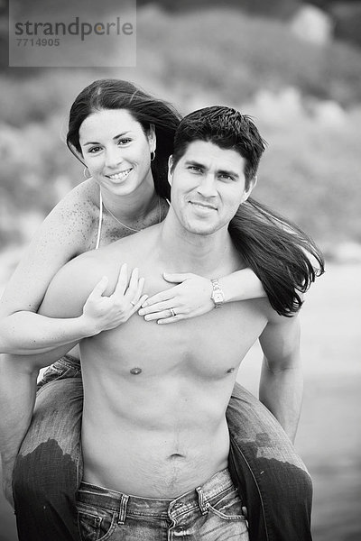 Couple Piggybacking On A Beach  Encinitas California Usa