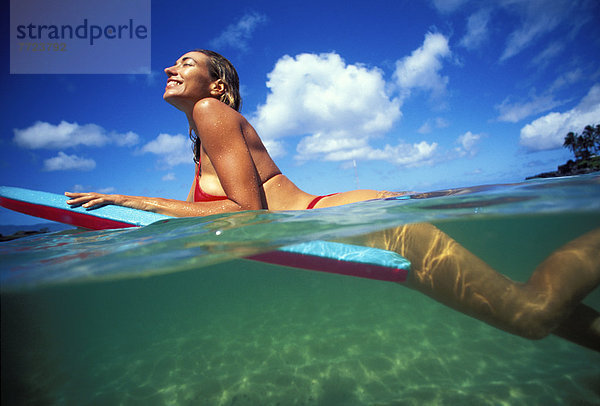 Woman Laying On Boogie Board  Over/Under Shot With Turquoise Water