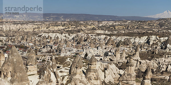 Rock Formations And A Cityscape  Goreme Nevsehir Turkey