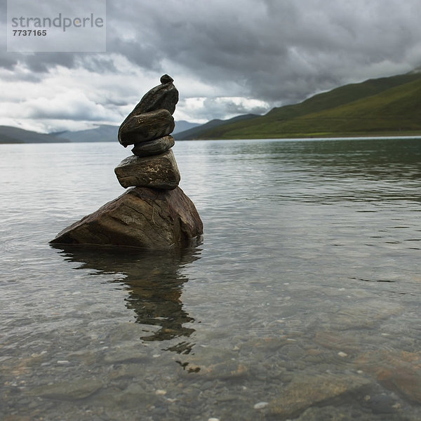 sitzend  Wasser  Küste  See  seicht  Heiligkeit  vorwärts  Steinhaufen