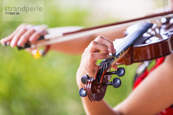 USA  Texas  Young woman playing violin  close up