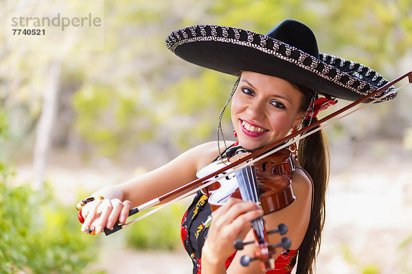 USA  Texas  Young woman playing violin  smiling  portrait