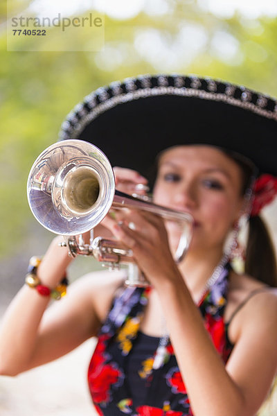 USA  Texas  Young woman playing trumpet