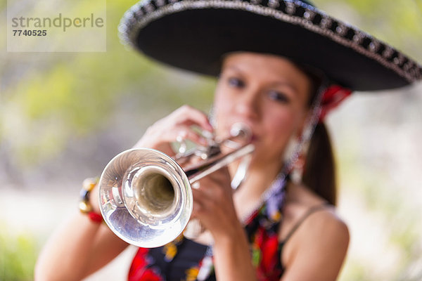 USA  Texas  Young woman playing trumpet