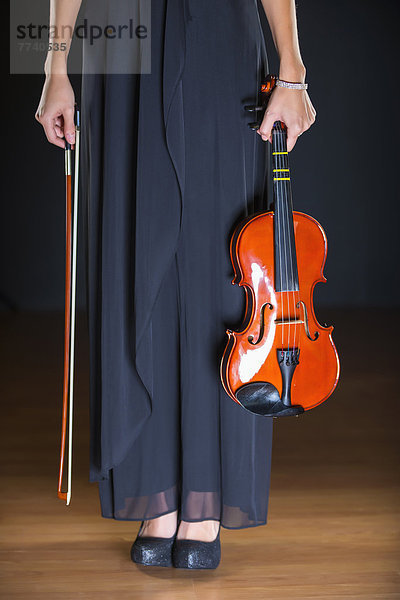 Young woman holding violin