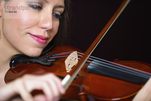 Young woman playing violin  smiling