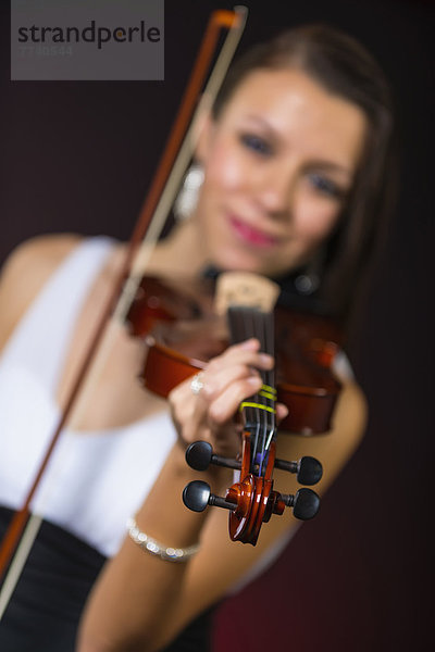Young woman playing violin  smiling