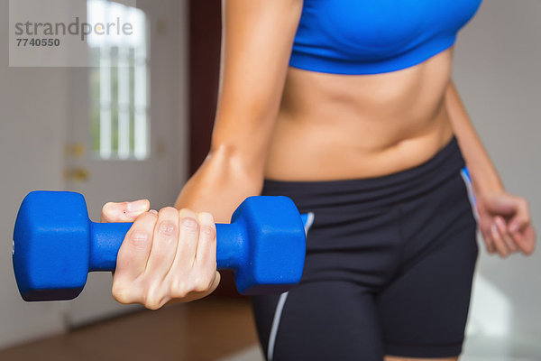 Young woman exercising with hand weight  close up