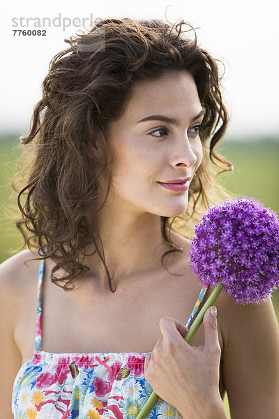 Porträt einer jungen Frau mit einer Blume