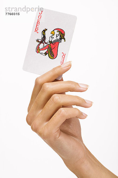 Frauenhand mit Spielkarte (Joker)