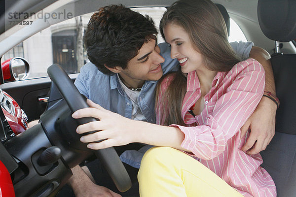 Portrait of couple in car  man embracing woman