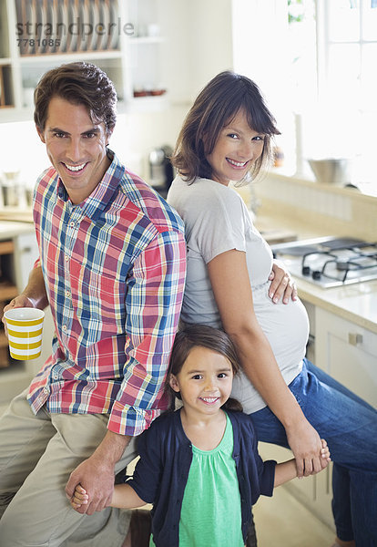 Familie lächelt gemeinsam in der Küche