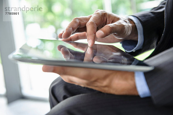 Reife Geschäftsleute mit digitalem Tablett
