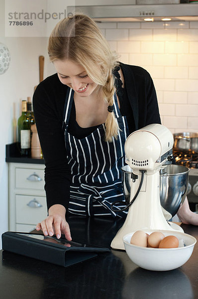 Frau mit digitalem Tablett zur Rezeptkontrolle