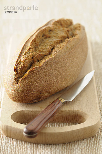 hoch  oben  nahe  Studioaufnahme  einsteigen  Brot  schneiden  Messer  Brotlaib  Hintergrund  braun