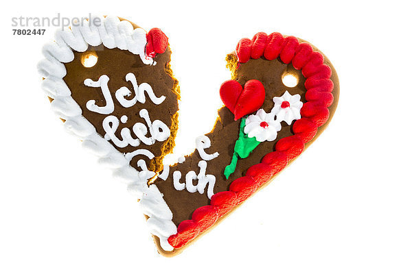 'Zerbrochenes Lebkuchenherz mit Schriftzug ''Ich liebe dich''  Symbolbild für Trennung  Scheidung'