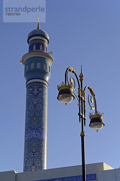 Die blaue Minarett der Rasool Azam Moschee  mit Straßenlaterne an der Corniche von Muttrah