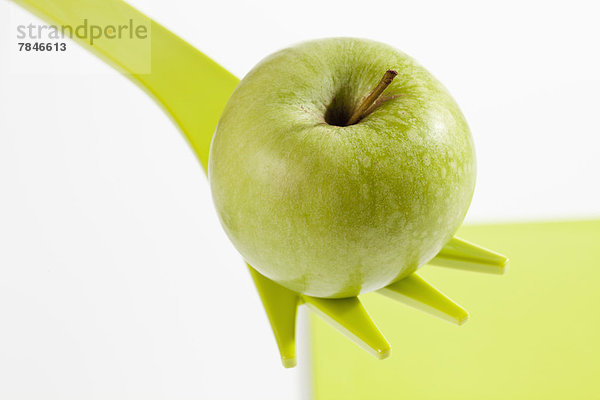 Green apple on fork  close up